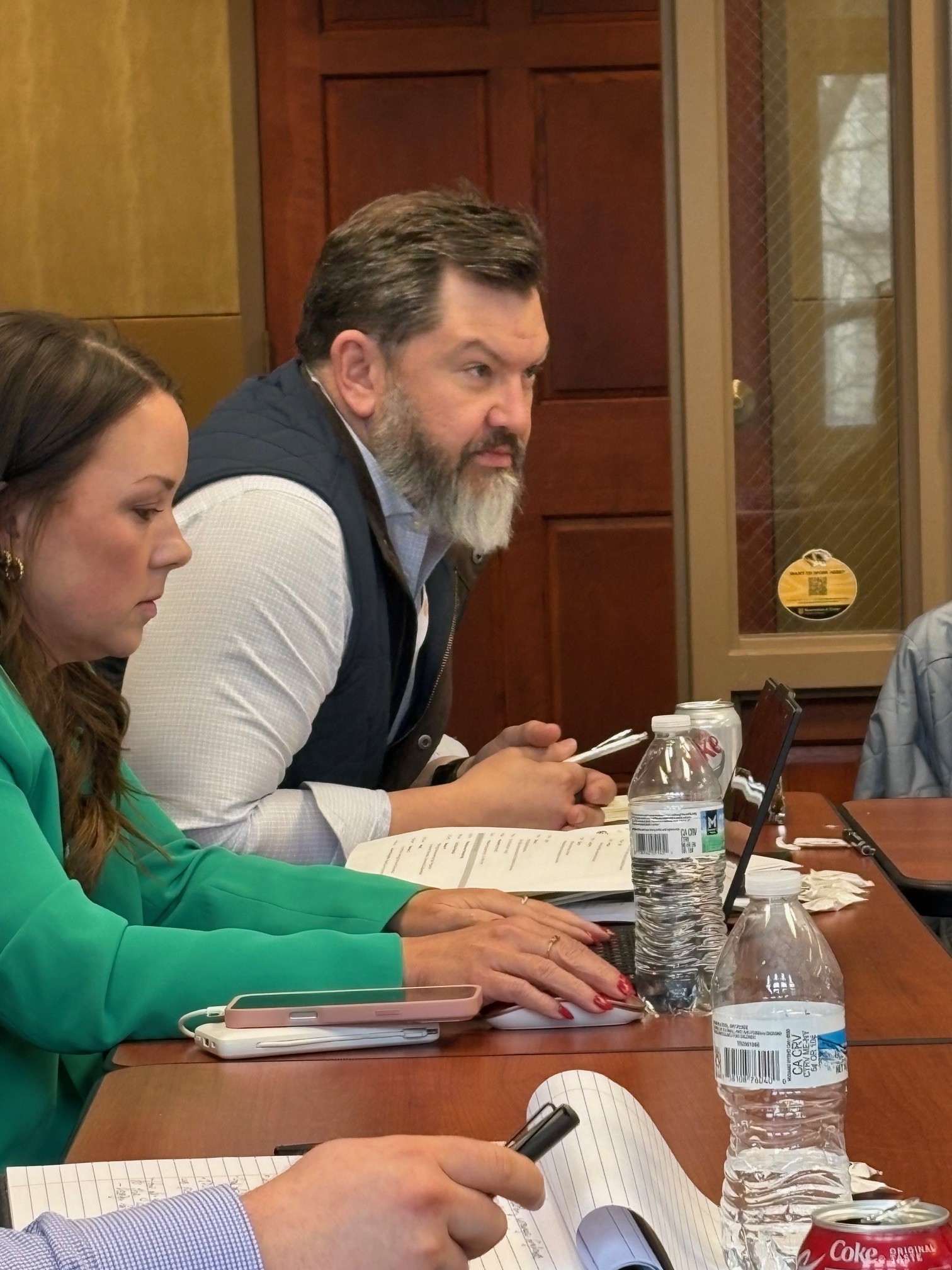A utility commissioner and a industry professional engage in discussion within their cohort. 